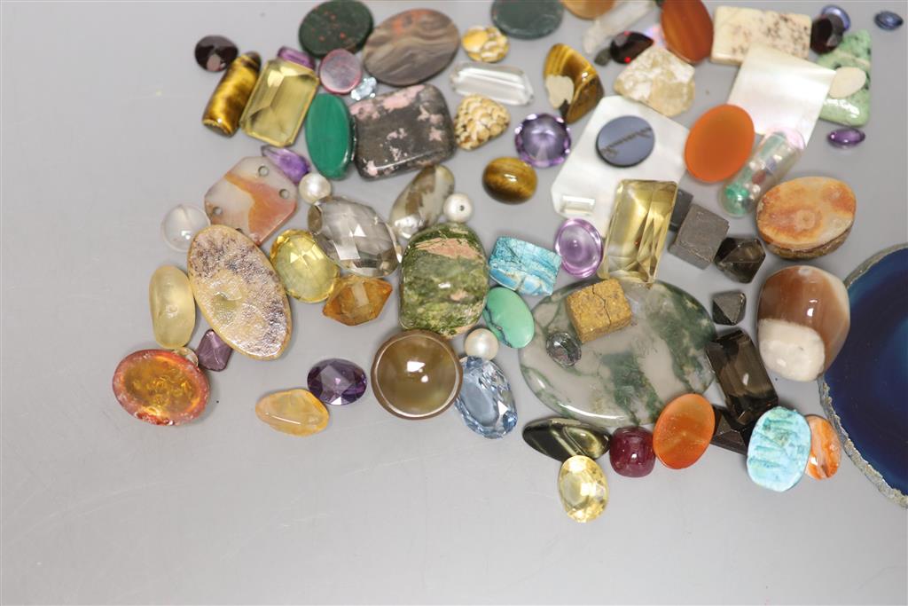 A group of loose precious and semi precious stones, including citrine, moss agate, tigers eye quartz etc.